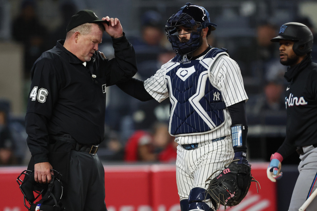 New York Yankees catcher Austin Wells (28) checks on home plate umpire Ron Kulpa during the fourth inning of a baseball game against the Miami Marlins, Saturday, April 4, 2026, in New York. (AP Photo/Heather Khalifa)