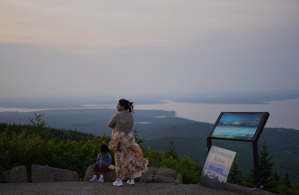 Visitors at the summit of Cadillac Mountain in Acadia National Park in Maine, on Tuesday, July 1, 2026. (AP Photo/Jessie Wardarski)