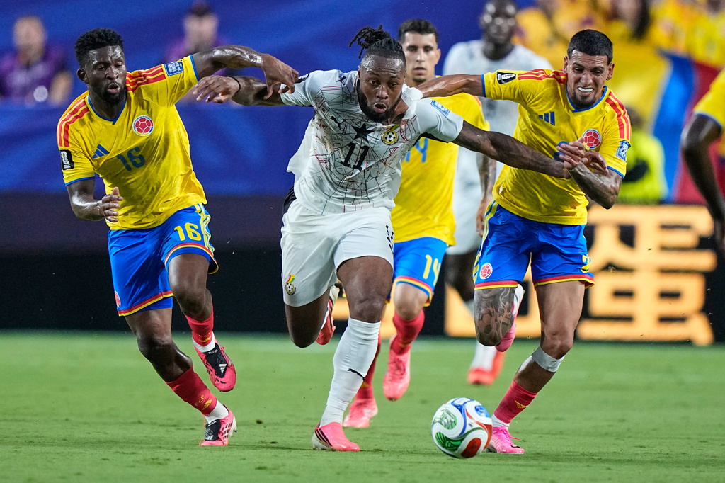 Ghana's Antoine Semenyo (11) battles for the ball Colombia's Jefferson Lerma (16) and Daniel Munoz (2) during the World Cup round of 32 soccer match between Colombia and Ghana in Kansas City, Mo., Friday, July 3, 2026. (AP Photo/Charlie Riedel)