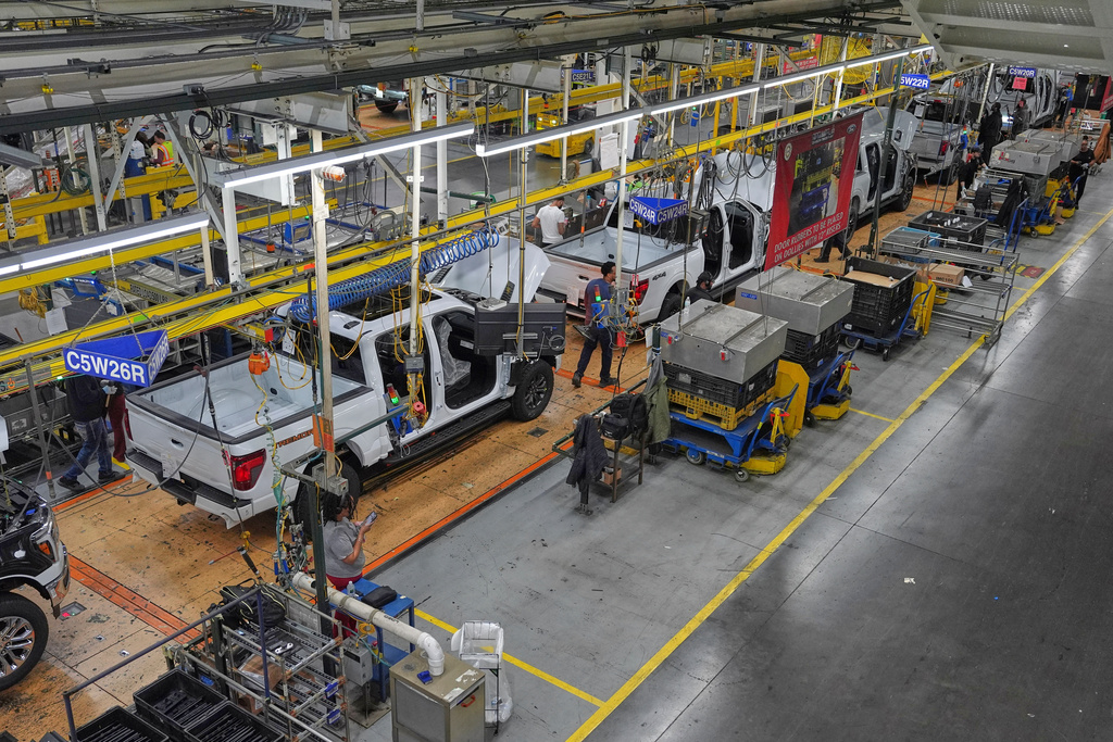 Employees work on the assembly line at the Ford River Rogue complex, Tuesday, Jan. 13, 2026, in Dearborn, Mich. (AP Photo/Evan Vucci)