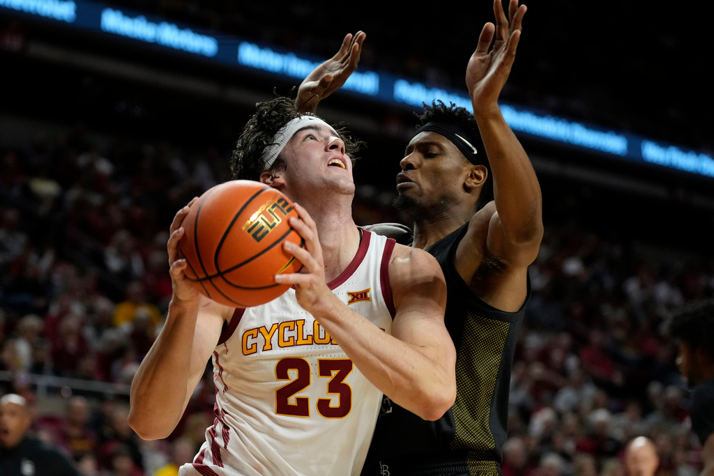 Iowa State forward Blake Buchanan (23) drives past Long Beach State guard Cole Farrell during the first half of an NCAA college basketball game, Sunday, Dec. 21, 2025, in Ames, Iowa. (AP Photo/Charlie Neibergall)