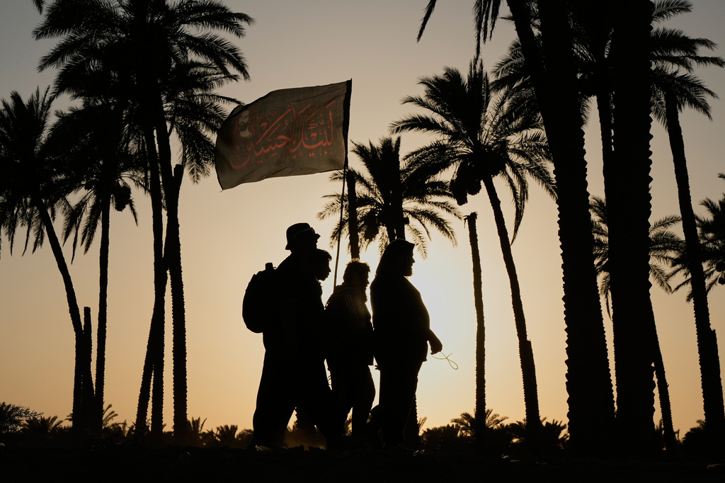 Shiite pilgrims march to Karbala for Arbaeen, the annual Shiite commemoration marking 40 days after Ashura, in Babil, Iraq, Saturday, Aug. 1, 2026. (AP Photo/Hadi Mizban)