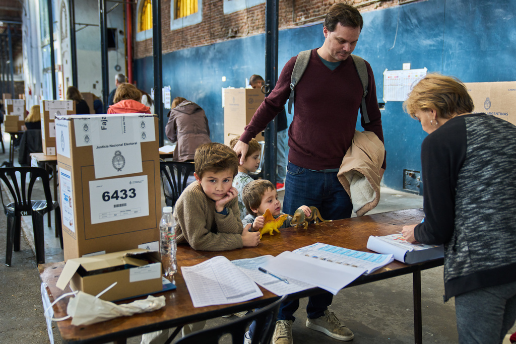 Patricio Irarrazabal arrives to vote with his sons during legislative midterm elections in Buenos Aires, Argentina, Sunday, Oct. 26, 2025. (AP Photo/Rodrigo Abd)