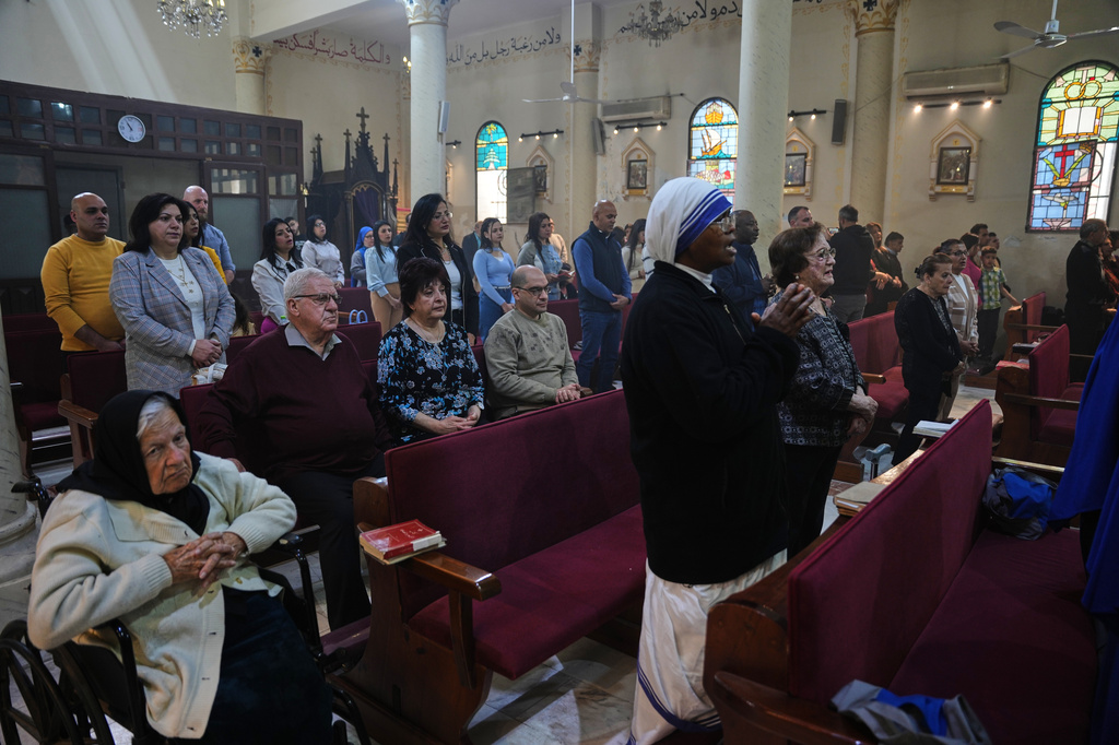 Christian worshippers attend an Easter mass at the Church of the Holy Family in Gaza City, Sunday, April 5, 2026. (AP Photo/Abdel Kareem Hana)