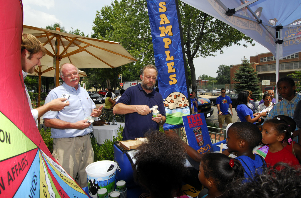 Ben Cohen, second from left, and Jerry Greenfield, center, founders of Ben & Jerry Homemade Inc., serve ice cream to Washington residents July 12, 2006, to kick off a federal budgets priority campaign. (AP Photo/Nick Wass)