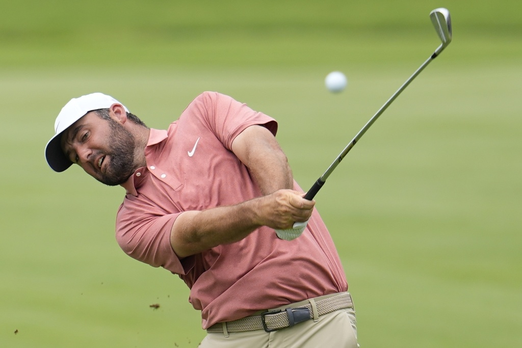 Scottie Scheffler hits from the first fairway during the first round of the Tour Championship golf tournament, Thursday, Aug. 21, 2025, in Atlanta. (AP Photo/Mike Stewart)