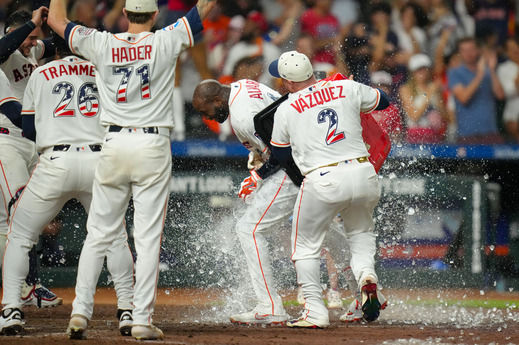 Houston Astros' Christian Vázquez dumps an ice chest on Houston Astros designated hitter Yordan Alvarez after he hit a walk-off home run during the ninth inning of a baseball game against the Tampa Bay Rays in Houston, Saturday, July 4, 2026. (AP Photo/Jon Shapley)
