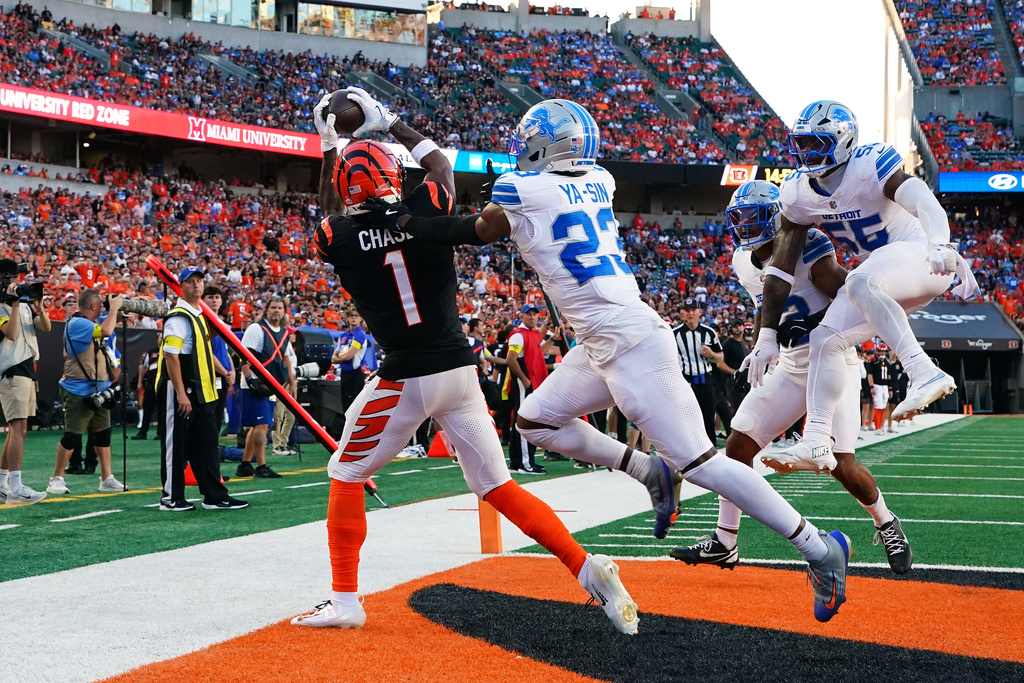 Cincinnati Bengals wide receiver Ja'Marr Chase (1) catches a 15-yard touchdown pass as Detroit Lions cornerback Rock Ya-Sin (23) defends during the second half of an NFL football game Sunday, Oct. 5, 2025, in Cincinnati. (AP Photo/Jeff Dean)