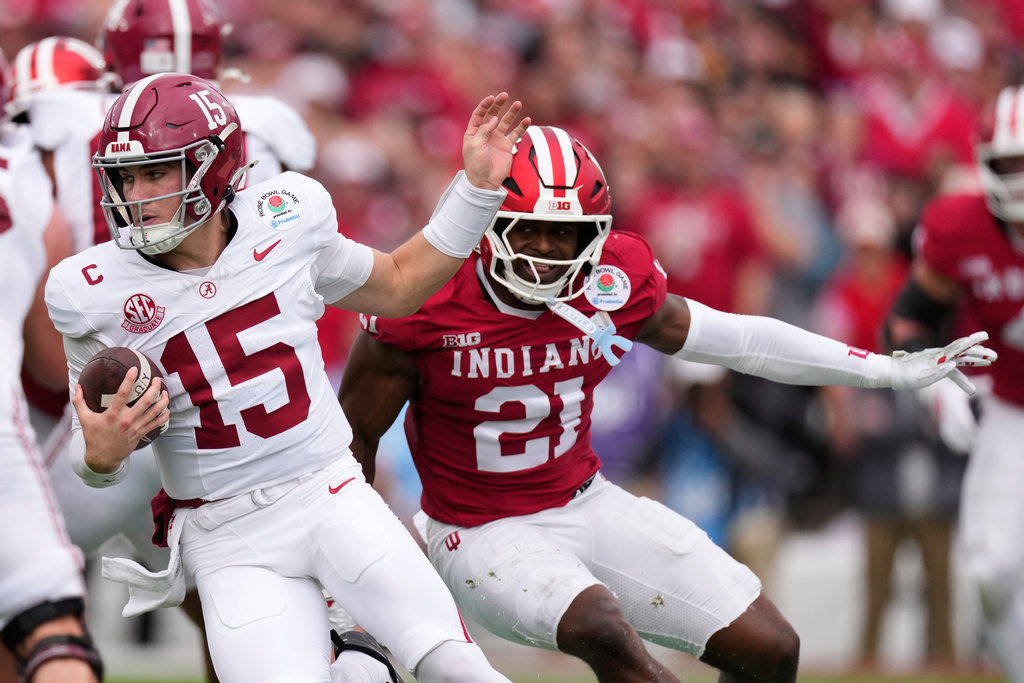 Alabama quarterback Ty Simpson (15), left, is chased by Indiana linebacker Rolijah Hardy (21) during the first half of the Rose Bowl College Football Playoff quarterfinal game Thursday, Jan. 1, 2026, in Pasadena, Calif. (AP Photo/Mark J. Terrill)