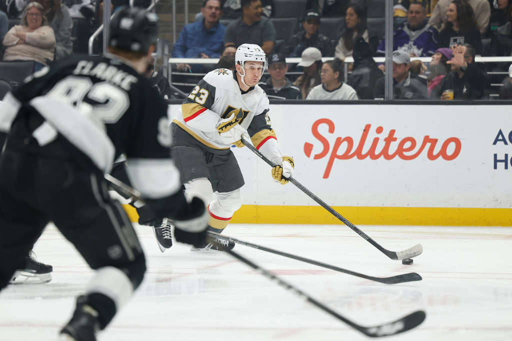 Vegas Golden Knights left wing Cole Reinhardt (23) looks to take a shot on goal as Los Angeles Kings defenseman Brandt Clarke (92) defends during the first period of an NHL hockey game Wednesday, Jan. 14, 2026, in Los Angeles. (AP Photo/Caroline Brehman)