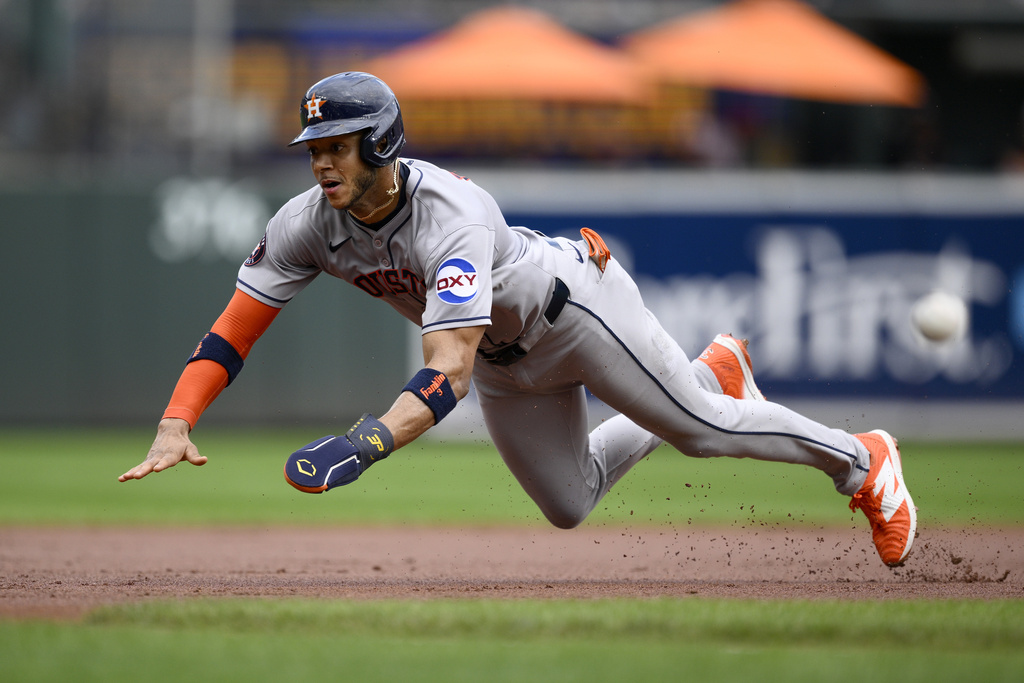 Houston Astros' Jeremy Pena dives as he steals third base during the first inning of a baseball game against the Baltimore Orioles, Sunday, Aug. 24, 2025, in Baltimore. (AP Photo/Nick Wass)