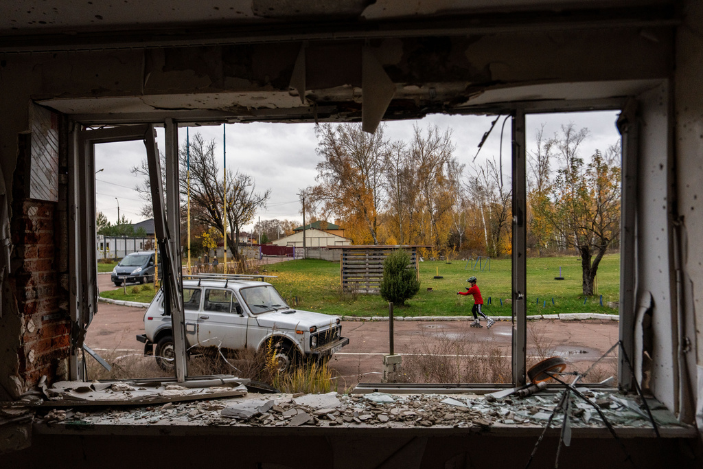 A young biathlete trains outside the destroyed ski base in Chernihiv, Ukraine, Thursday, Oct. 30, 2025. (AP Photo/Julia Demaree Nikhinson)