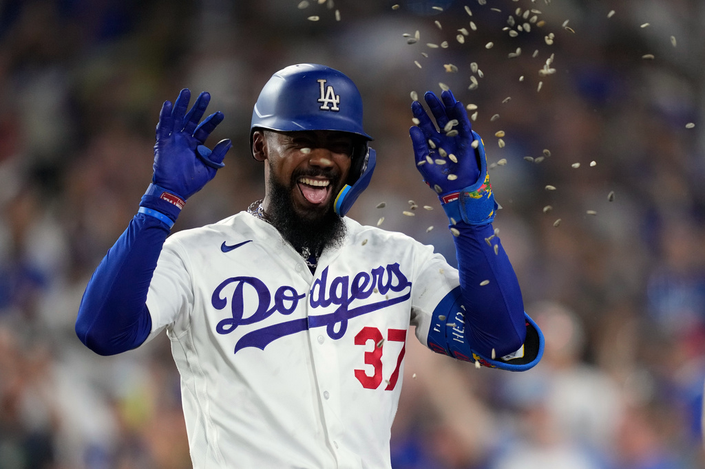 Los Angeles Dodgers' Teoscar Hernández has seeds thrown at him after hitting a three-run home run during the sixth inning of a baseball game against the Cincinnati Reds, Monday, Sept. 7, 2026, in Los Angeles. (AP Photo/Mark J. Terrill)