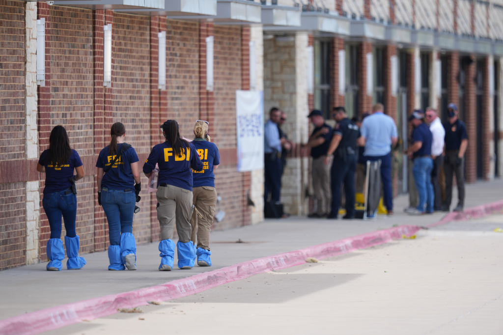 Officials respond to the scene of a shooting Tuesday, May 5, 2026, at K Towne Plaza in Carrollton, Texas. (AP Photo/Julio Cortez)