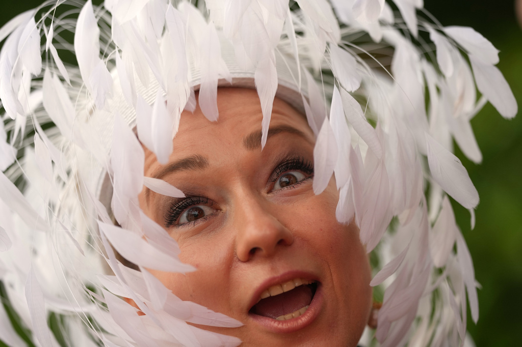A racegoer reacts as she arrives on the third day of the Royal Ascot horse race meeting, traditionally called Ladies Day in Ascot, England, Thursday, June 18, 2026. (AP Photo/Alastair Grant)
