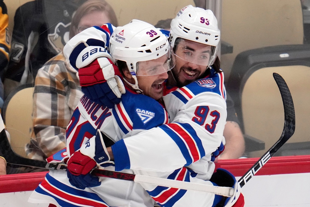 New York Rangers' Mika Zibanejad (93) celebrates his goal with Sam Carrick during the first period of an NHL hockey game against the Pittsburgh Penguins in Pittsburgh, Saturday, Oct. 11, 2025. (AP Photo/Gene J. Puskar)