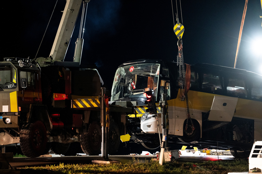 Emergency responders recover a travel coach after an accident in Susch in the canton of Grisons, Switzerland, on Friday, Sept. 11, 2026. (Claudio Thoma/Keystone via AP)