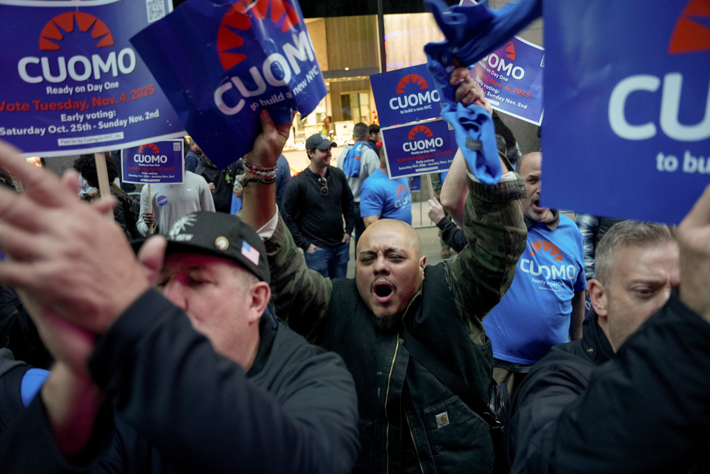 Supporters for independent candidate and former New York Gov. Andrew Cuomo, gather outside NBC Studios as they await the arrival of the candidates for a mayoral debate, Thursday, Oct. 16, 2025, in New York. (AP Photo/Angelina Katsanis)