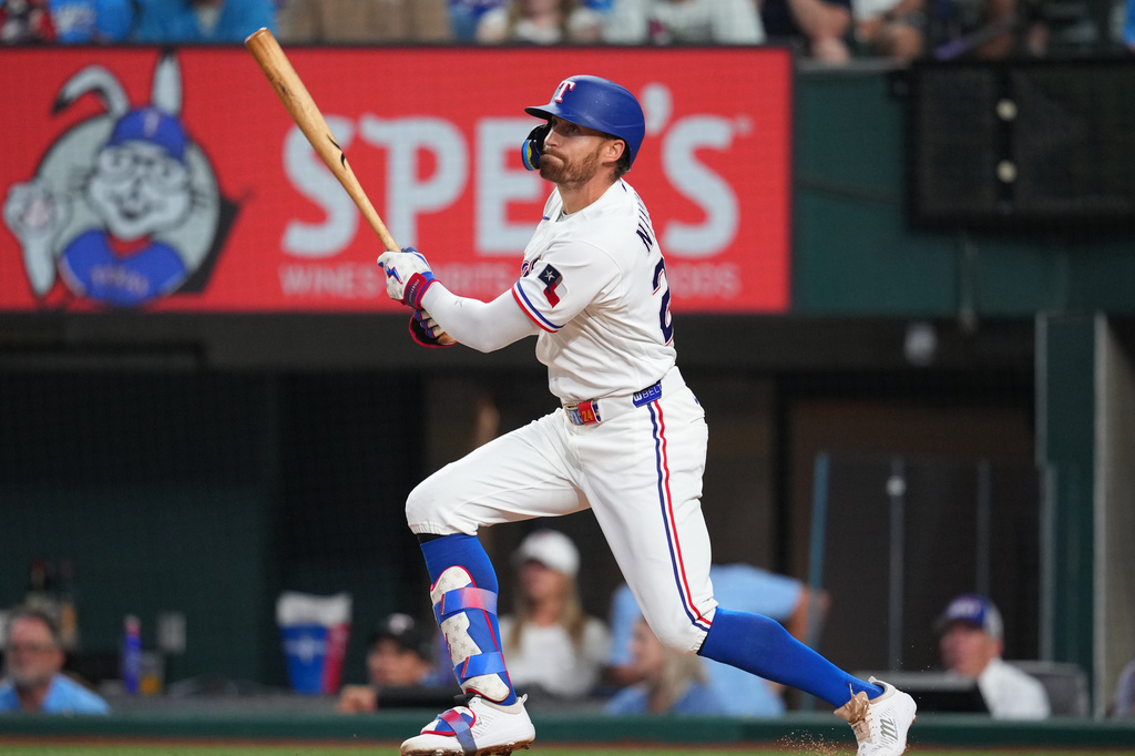 Texas Rangers' Brandon Nimmo watches his ball as he hits a sacrifice fly ball to score Danny Jansen during the third inning of a baseball game against the Athletics, Saturday, April 25, 2026, in Arlington, Texas. (AP Photo/Julio Cortez)