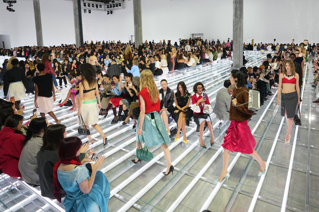 Models wear creations part of the Prada women's Spring-Summer 2027 collection presented in Milan, Italy, Tuesday, Sept. 22, 2026. (AP Photo/Luca Bruno).
