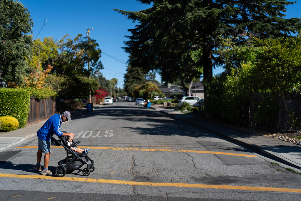 Christy Morrill, who lost decades of memories to autoimmune encephalitis, checks on his grandson, Colter, 1, while out on a walk, Tuesday, Aug. 19, 2025, in San Carlos, Calif. (AP Photo/David Goldman)