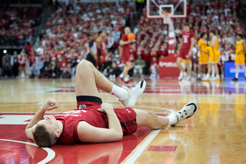 Wisconsin forward Aleksas Bieliauskas (32) reacts to an injury during the first half of an NCAA college basketball game against Minnesota Wednesday, Jan. 28, 2026, in Madison, Wis. (AP Photo/Kayla Wolf)