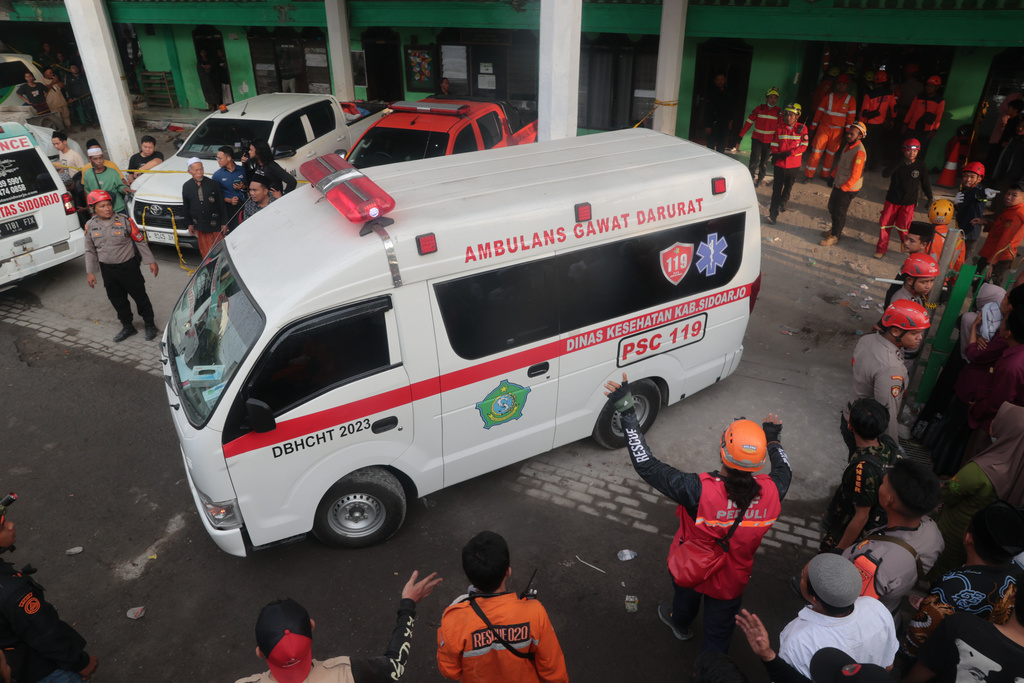 An ambulance parks outside the compound where a building under construction collapsed at an Islamic boarding school in Sidoarjo, East Java, Indonesia, Tuesday, Sept. 30, 2025. (AP Photo/Trisnadi)