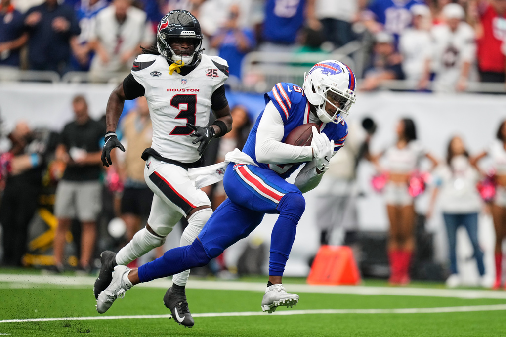 Buffalo Bills wide receiver Joshua Palmer, right, runs the ball into the end zone for a touchdown past Houston Texans cornerback Kamari Lassiter (3) during the second half of an NFL football game, Sunday, Sept. 13, 2026, in Houston. (AP Photo/Ashley Landis)