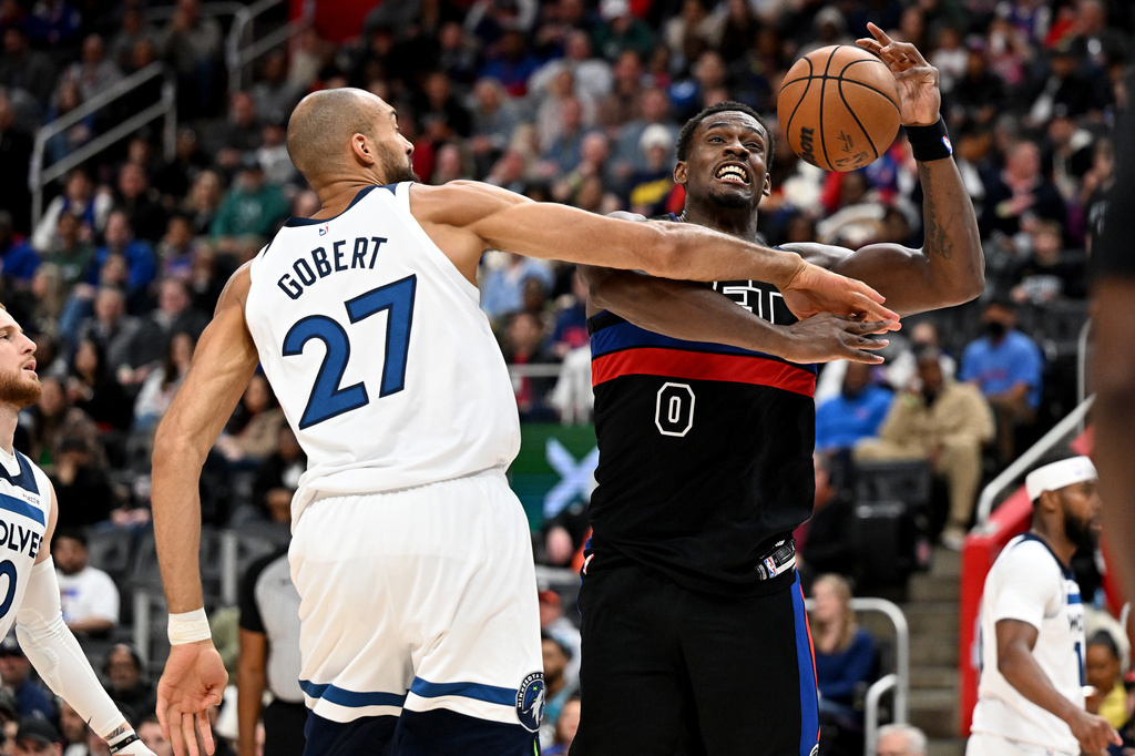 Detroit Pistons center Jalen Duren (0) gets fouled by Minnesota Timberwolves center Rudy Gobert (27) while driving to the basket in the first half of an NBA basketball game Thursday, April 2, 2026, in Detroit. (AP Photo/Lon Horwedel)
