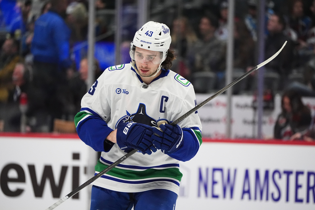 Vancouver Canucks defenseman Quinn Hughes waits for play to begin in the third period of an NHL hockey game against the Colorado Avalanche Tuesday, Dec. 2, 2025, in Denver. (AP Photo/David Zalubowski)