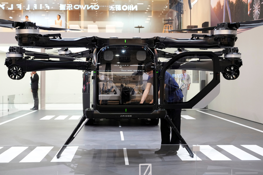 A worker prepares a flying vehicle from XPENG during Auto China 2026 in Beijing, Friday, April 24, 2026. (AP Photo/Ng Han Guan)