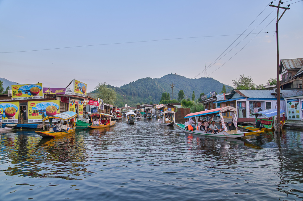 Tourists enjoy a ride on a traditional boat near the floating market on Dal Lake in Srinagar, Indian controlled Kashmir, Monday, June 1, 2026. (AP Photo/Dar Yasin)