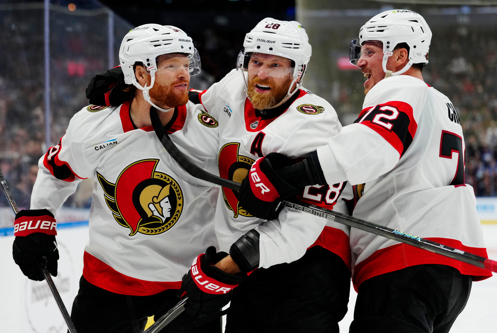 Ottawa Senators' Stephen Halliday, left, celebrates after his goal against the Toronto Maple Leafs with Claude Giroux (28) and Thomas Chabot (72) during the third period of an NHL hockey game in Toronto, Saturday, Oct. 3, 2026. (Frank Gunn/The Canadian Press via AP)