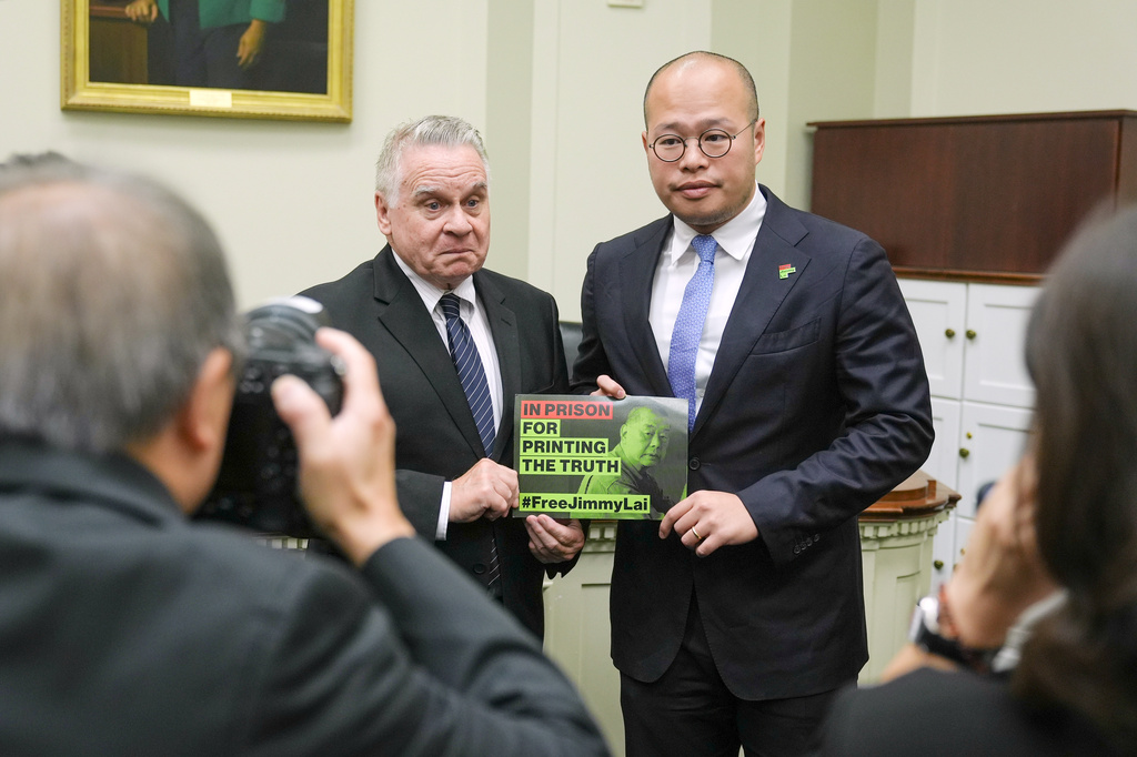 Sebastien Lai speaks, right and Rep. Chris Smith, R-N.J., left, stand for a photo after a Congressional Executive Commission on China regarding the continued imprisonment of his father Jimmy Lai on Capitol Hill, Wednesday, Sept. 16, 2026, in Washington. (AP Photo/Mariam Zuhaib)