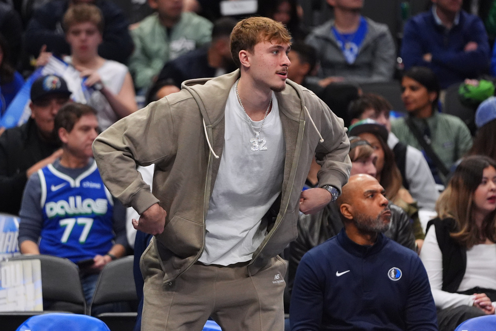 Injured Dallas Mavericks forward Cooper Flagg watches from the bench during the first half of an NBA basketball game against the Utah Jazz in Dallas, Thursday, Jan. 15, 2026. (AP Photo/LM Otero)