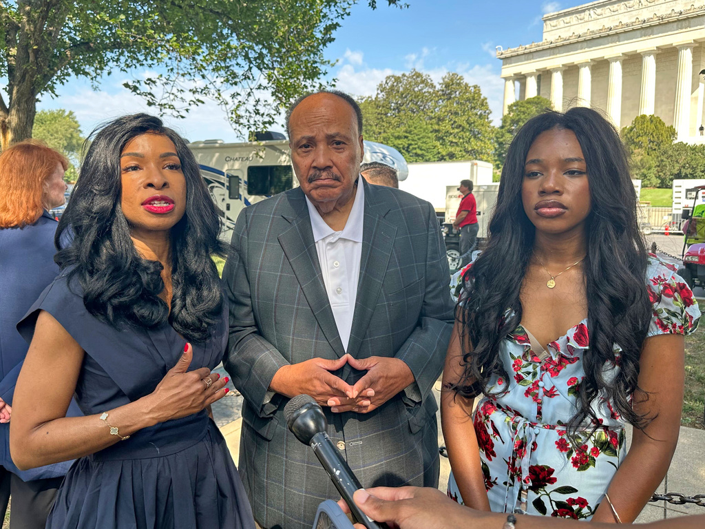 Arndrea Waters King, from left, Martin Luther King III and their daughter Yolanda Renee King participate in an interview before the March on Washington, Friday, Aug. 28, 2026, near the Lincoln Memorial in Washington. (AP Photo/Nathan Ellgren)