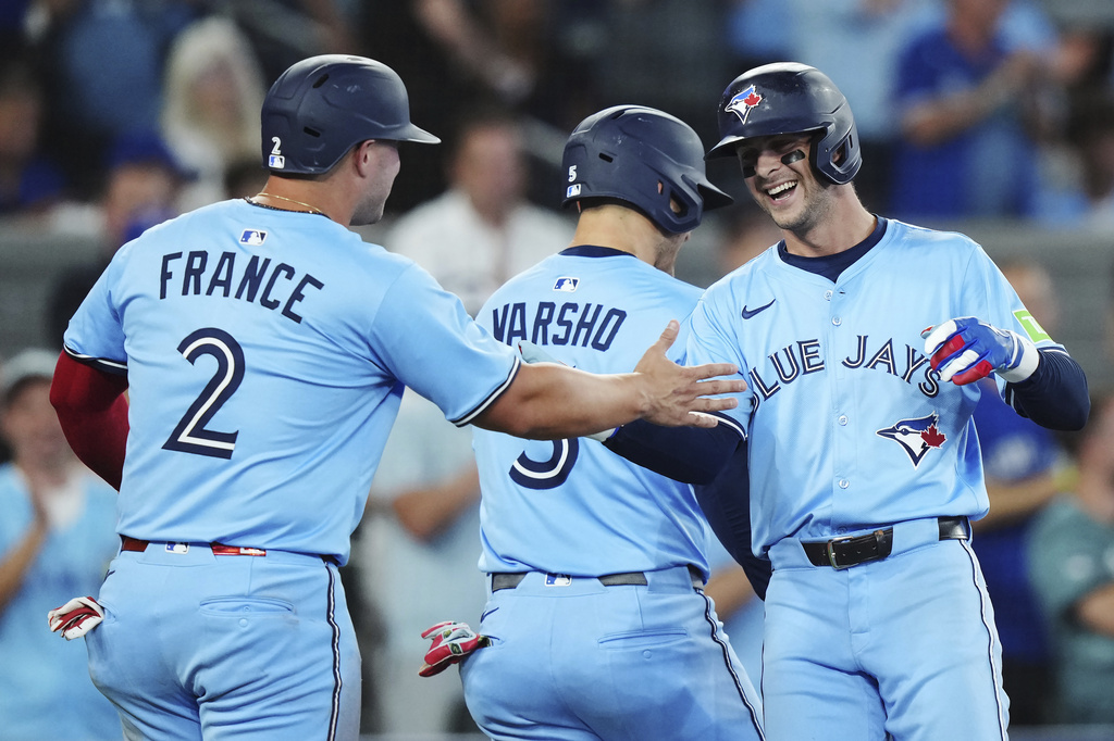 Toronto Blue Jays' Ernie Clement (right) celebrates his three-run home run against the Chicago Cubs with Ty France (2) and Daulton Varsho (5) during fourth inning MLB baseball action in Toronto on Tuesday, August 12, 2025. (Nathan Denette/The Canadian Press via AP)