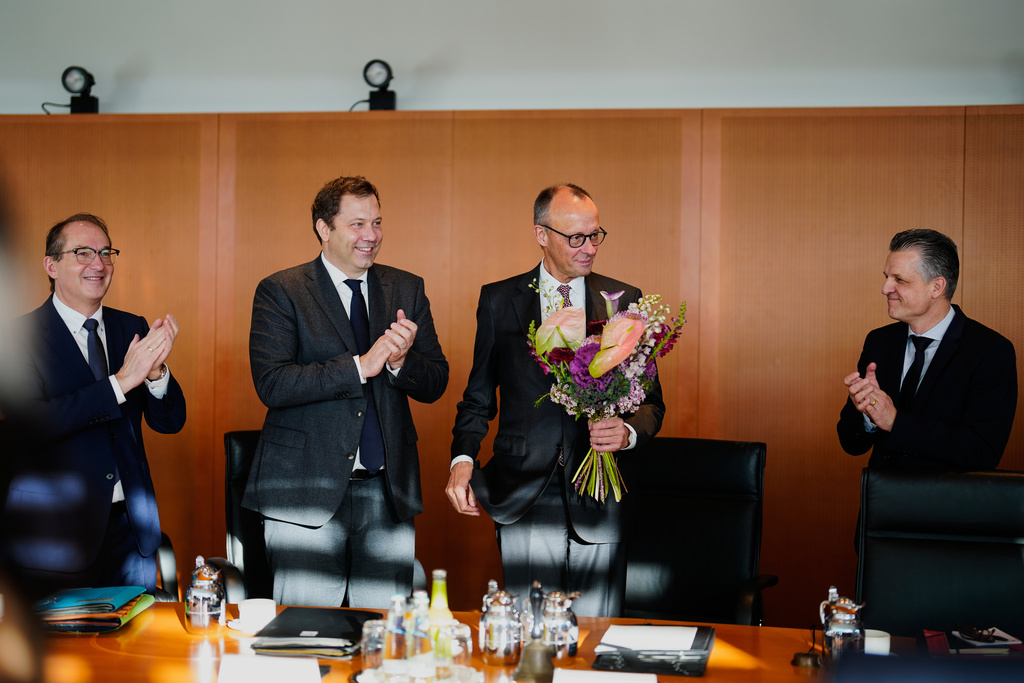 German Interior Minister Alexander Dobrindt, left, Vice Chancellor and Finance Minister Lars Klingbeil, second from left, and Head of the Chancellery Thorsten Frei, right, congratulate Chancellor Friedrich Merz, second from right, on his 70th birthday, which he celebrated on Tuesday, Nov. 11, prior to the cabinet meeting at the Chancellery in Berlin, Germany, Wednesday, Nov. 12, 2025.(AP Photo/Markus Schreiber)