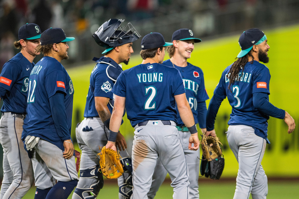 The Seattle Mariners celebrate after winning a baseball game against the Athletics in West Sacramento, Calif., Monday, May 25, 2026. (AP Photo/Nic Coury)