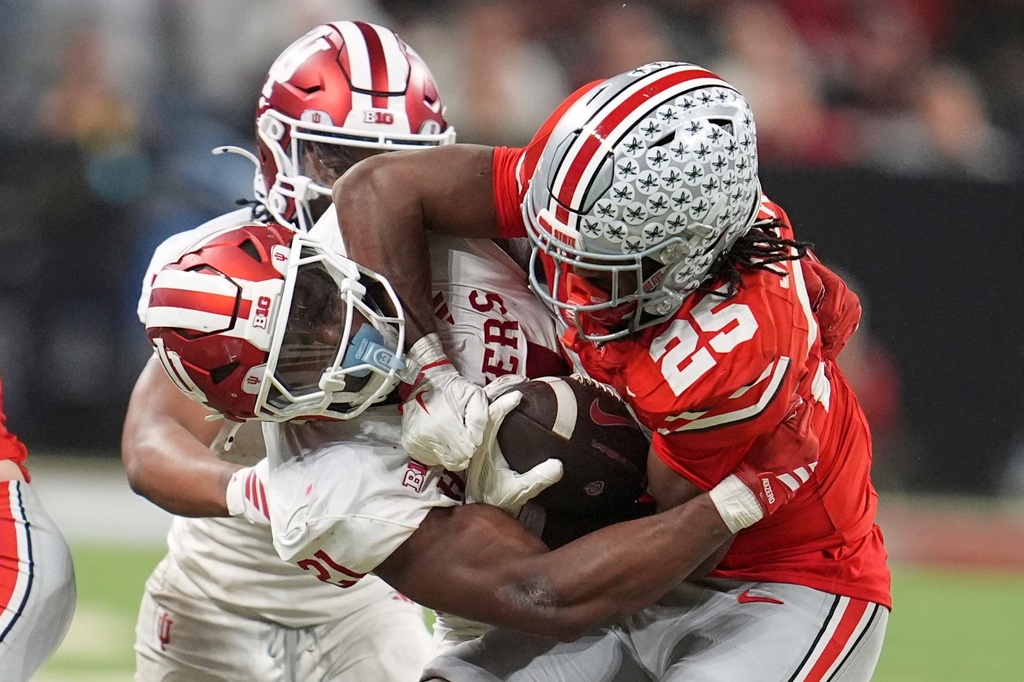 Indiana's Louis Moore tries to stop Ohio State's Bo Jackson during the second half of the Big Ten championship NCAA college football game in Indianapolis, Saturday, Dec. 6, 2025. (AP Photo/Michael Conroy)