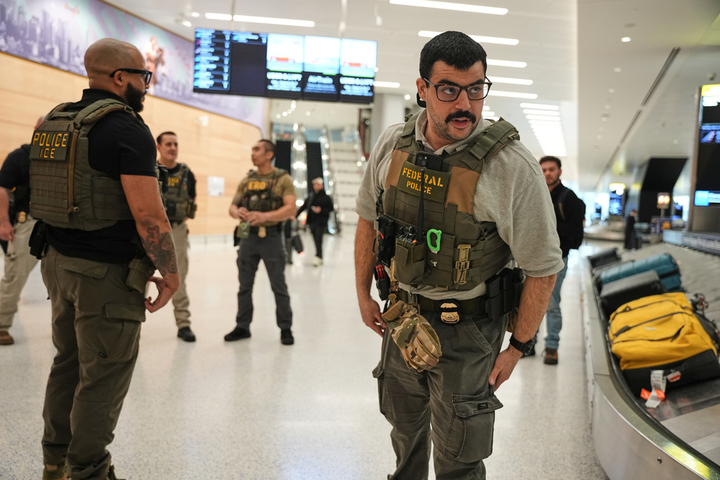 Federal immigration agents are seen at Newark Liberty International Airport, Monday, March 23, 2026, in Newark, N.J. (AP Photo/Angelina Katsanis)