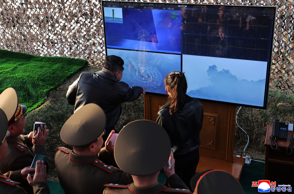 In this photo provided by the North Korean government, its leader Kim Jong Un, rear left, with his daughter observes what it says a test launch of an upgraded surface-to-surface ballistic missile at an undisclosed place in North Korea Sunday, April 19, 2026. Independent journalists were not given access to cover the event depicted in this image distributed by the North Korean government. The content of this image is as provided and cannot be independently verified. Korean language watermark on image as provided by source reads: "KCNA" which is the abbreviation for Korean Central News Agency. (Korean Central News Agency/Korea News Service via AP)