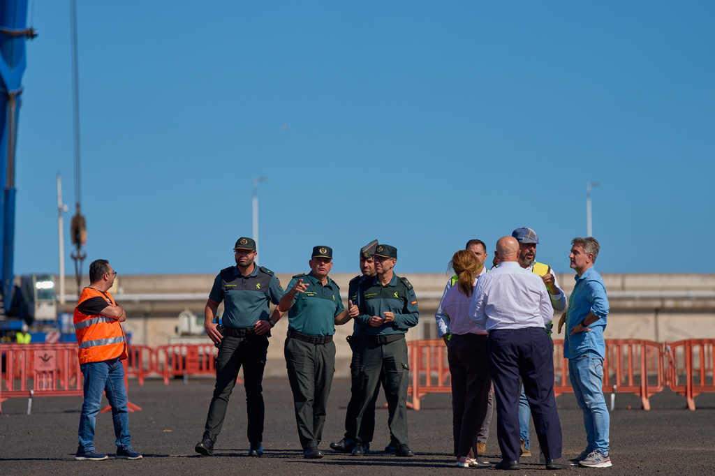 Spanish Civil Guard officers and port authorities inspect the area where passengers from the MV Hondius cruise ship are expected to arrive at the port of Granadilla in Tenerife, Canary Islands, Spain, Friday, May 8, 2026. (AP Photo/Manu Fernandez)