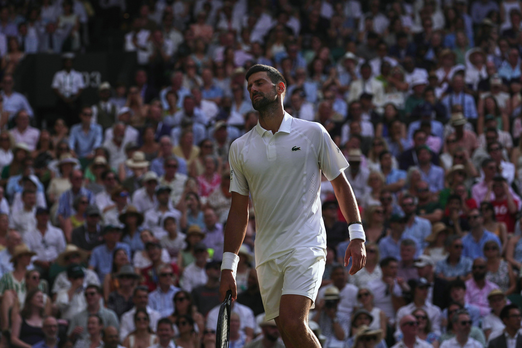 Novak Djokovic of Serbia reacts to losing a point against Jannik Sinner of Italy in their men's singles semifinal match at the Wimbledon Tennis Championships in London, Friday, July 10, 2026. (AP Photo/Brian Inganga)