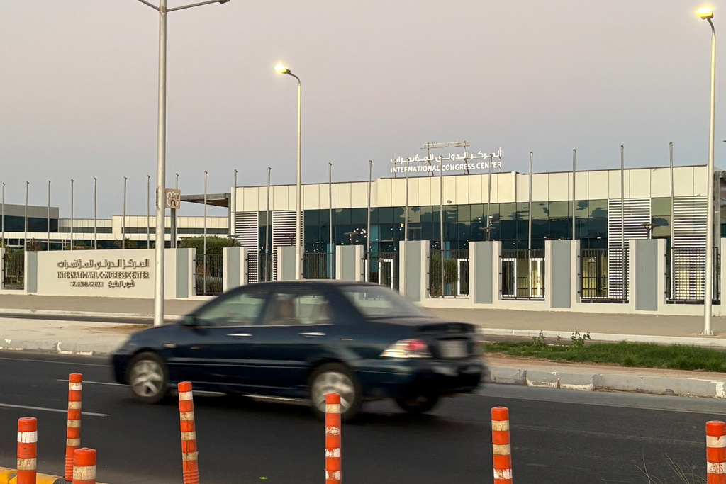 A vehicle passes in front of the International Conference Center where Israeli and Hamas officials are set to hold indirect talks Wednesday, Oct. 8, 2025. (AP Photo)