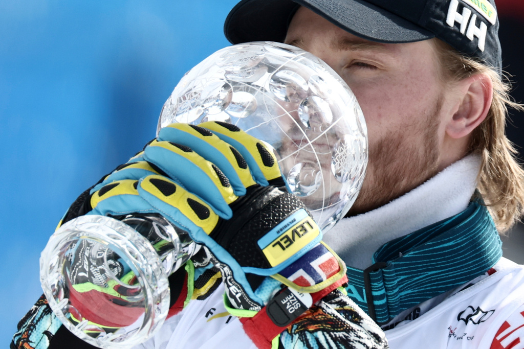 Norway's Atle Lie McGrath kisses the globe trophy for the alpine ski, men's slalom discipline, at the Lillehammer World Cup Finals, in Hafjell, Norway, Wednesday, March 25, 2026. (AP Photo/Gabriele Facciotti)