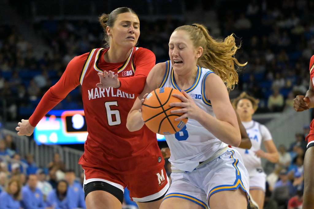 UCLA guard Gianna Kneepkens (8) is defended by Maryland guard Saylor Poffenbarger as she drive to the basket during the first half of an NCAA college basketball game Sunday, Jan. 18, 2026, in Los Angeles. (AP Photo/Jayne Kamin-Oncea)