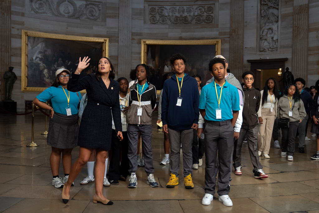 Rep. Alexandria Ocasio-Cortez, D-N.Y., gives a tour of the Capitol to a group of students from New York after their previously-scheduled tour was canceled due to the government shutdown on Wednesday, Oct. 1, 2025, in Washington. (AP Photo/Mark Schiefelbein)