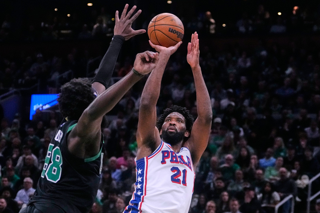 Philadelphia 76ers center Joel Embiid (21) takes a shot over Boston Celtics center Neemias Queta (88) during the second half of Game 5 of a first-round NBA playoffs basketball series, Tuesday, April 28, 2026, in Boston. (AP Photo/Charles Krupa)