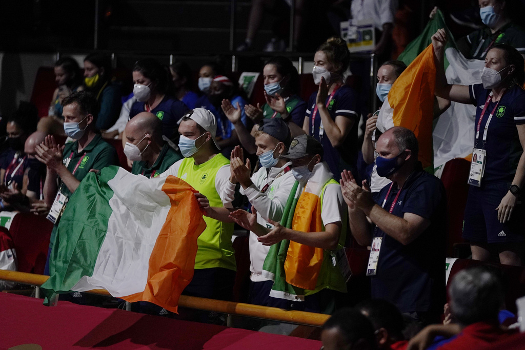 FILE - People with Irish flags hold them during the women's lightweight 60-kg boxing gold medal match between Ireland's Kellie Anne Harrington and Brazil's Beatriz Ferreira at the 2020 Summer Olympics, Sunday, Aug. 8, 2021, in Tokyo, Japan. (AP Photo/Frank Franklin II, File)